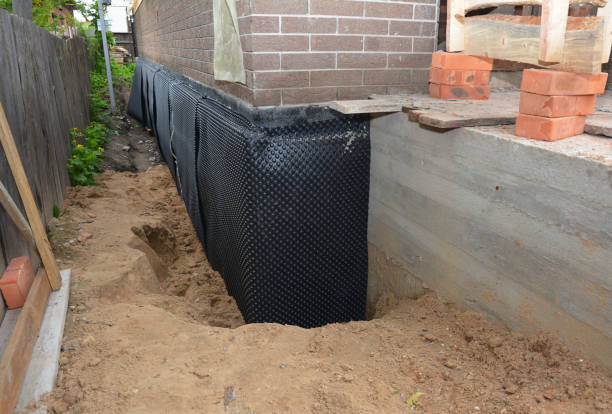 SJ Waterproofing Pros technician performing targeted Interior Drainage System assessment in Young America, IN